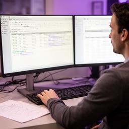 Casey W. demonstrating HeidiSQL on a workstation with clean query tables and notes